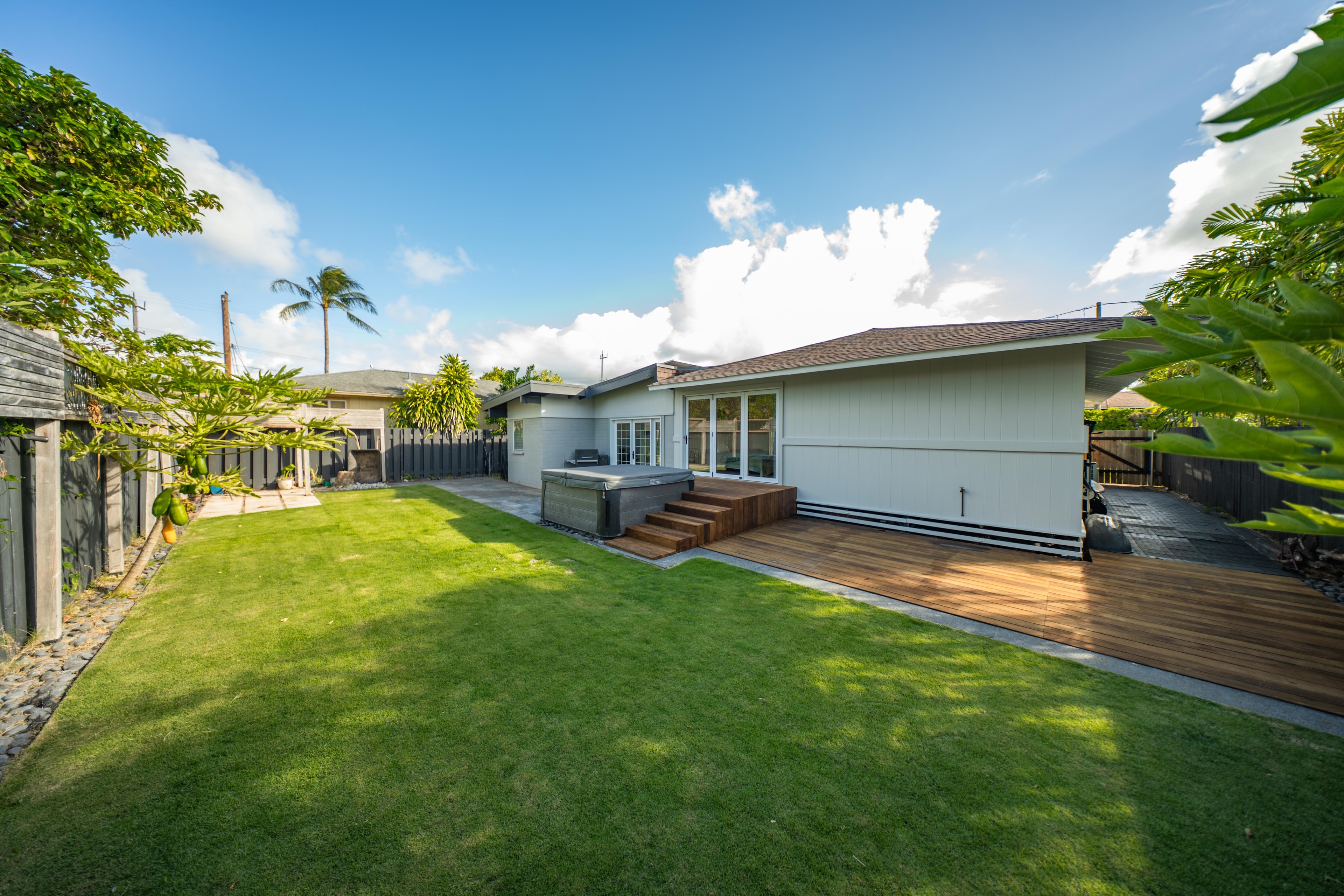 Front exterior with lush tropical landscaping